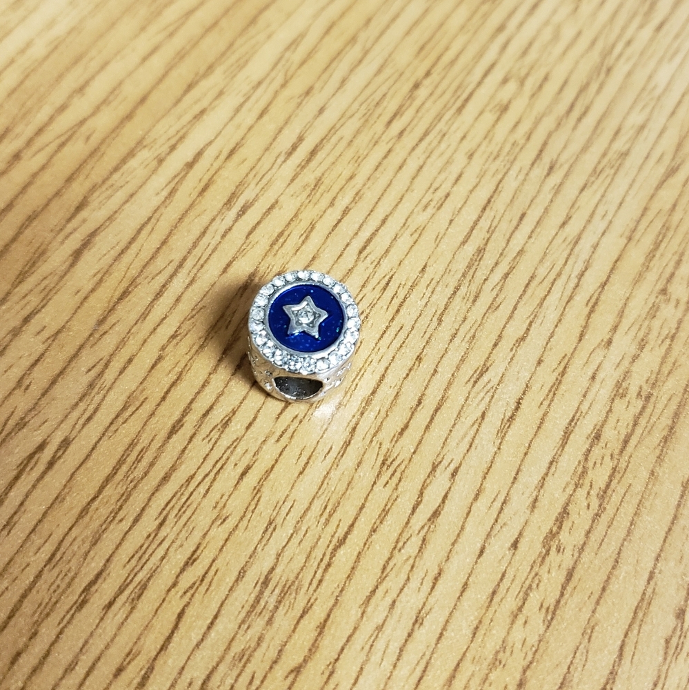 SILVER charm with star on blue background